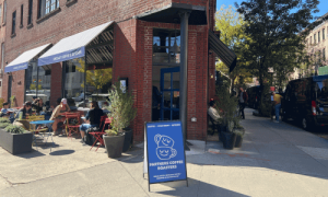 Partners Coffee West Village – Bright NYC Café 1 Outdoor view of Partners Coffee West Village café on Charles Street, NYC — bright corner location with sidewalk seating and morning light.