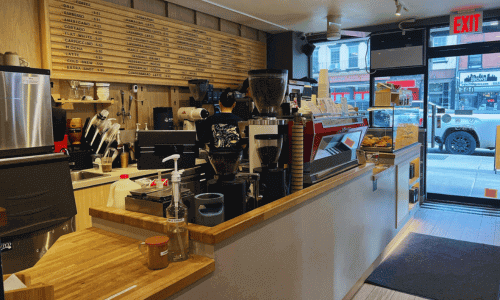 Espresso bar and menu wall inside Kona Coffee Roasters Chelsea.