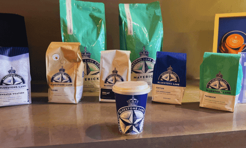 Bluestone Lane Chelsea Hudson Yards – Best Coffee NYC 2 cappuccino cup and coffee bean bags display at Bluestone Lane Chelsea Hudson Yards near the High Line NYC