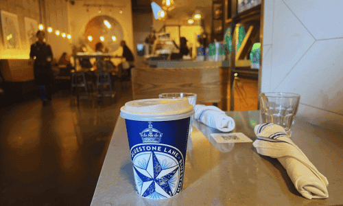 Bluestone Lane Chelsea Hudson Yards – Best Coffee NYC 3 coffee cup on table inside Bluestone Lane Chelsea Hudson Yards New York City café