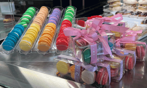 Charlotte Patisserie Chelsea – Best Bakery & Coffee NYC 3 colorful macarons and luxury desserts display at Charlotte Patisserie Chelsea near Chelsea Market New York City